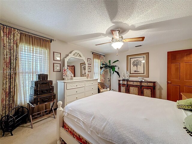547 Deer Creek Run, Deerfield Beach, FL 33442 - bedroom with ceiling fan, visible vents, a textured ceiling, and light colored carpet