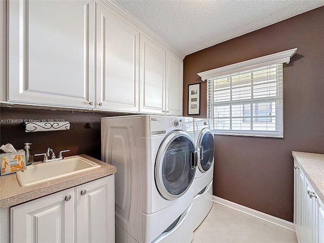 547 Deer Creek Run, Deerfield Beach, FL 33442 - washroom featuring a sink, a textured ceiling, washing machine and dryer, baseboards, and cabinet space