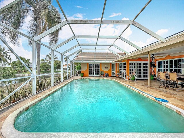 547 Deer Creek Run, Deerfield Beach, FL 33442 - outdoor pool with ceiling fan, french doors, a patio area, and a lanai