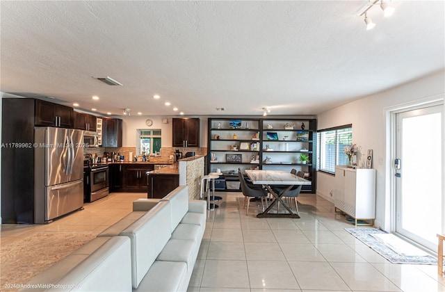 5901 NE 4th Ave, Oakland Park, FL 33334 - living room featuring visible vents, recessed lighting, a textured ceiling, and light tile patterned flooring