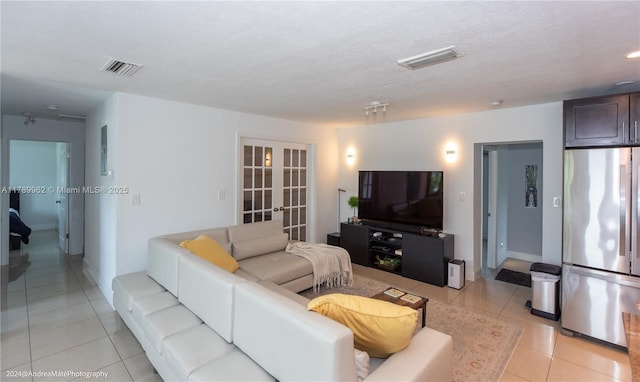 5901 NE 4th Ave, Oakland Park, FL 33334 - living room featuring baseboards, light tile patterned flooring, french doors, and visible vents