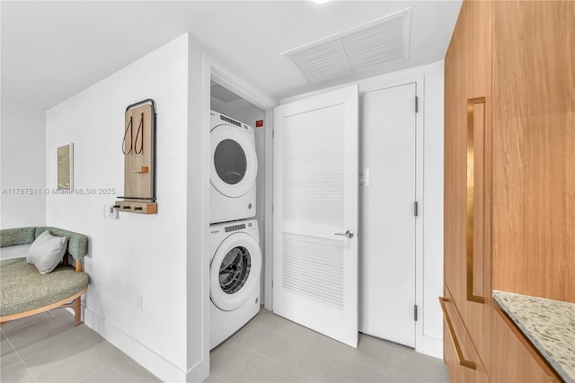 601NE 1st Ave Unit 4609, Miami, FL 33132 - washroom with baseboards, stacked washer and dryer, light tile patterned floors, and visible vents