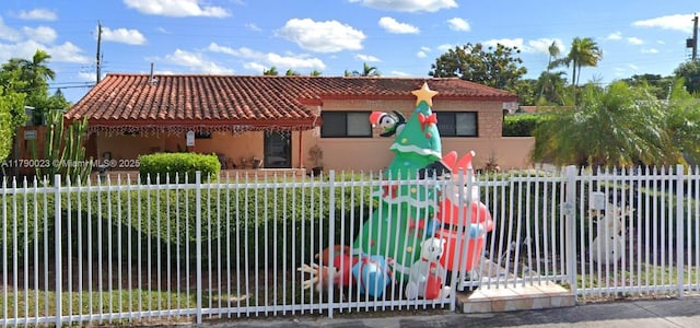 1335 SW 78th Ct, Miami, FL 33144 - view of front of home with a fenced front yard, stucco siding, and a tile roof
