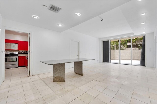 151 Crandon Blvd Unit 138, Key Biscayne, FL 33149 - interior space with visible vents, stainless steel electric range oven, expansive windows, recessed lighting, and light tile patterned flooring