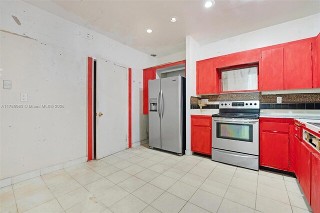 151 Crandon Blvd Unit 138, Key Biscayne, FL 33149 - kitchen featuring red cabinetry, light countertops, recessed lighting, and stainless steel appliances