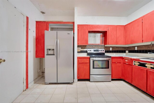 151 Crandon Blvd Unit 138, Key Biscayne, FL 33149 - kitchen with red cabinetry, light countertops, tasteful backsplash, and stainless steel appliances