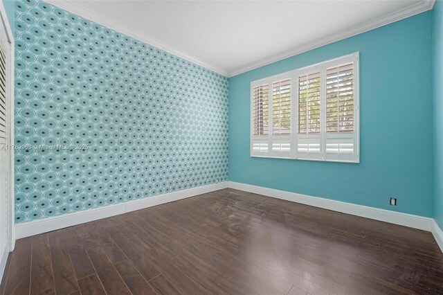 151 Crandon Blvd Unit 138, Key Biscayne, FL 33149 - spare room featuring crown molding, an accent wall, wood finished floors, baseboards, and wallpapered walls