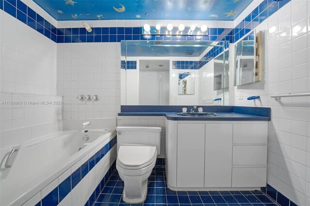 151 Crandon Blvd Unit 138, Key Biscayne, FL 33149 - bathroom with a relaxing tiled tub, tile patterned flooring, vanity, toilet, and tile walls