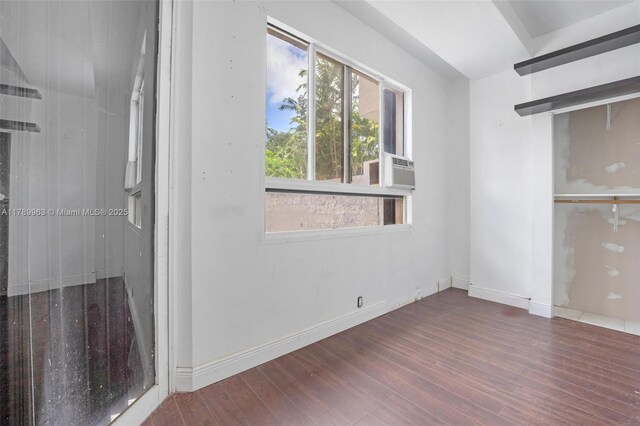 151 Crandon Blvd Unit 138, Key Biscayne, FL 33149 - unfurnished bedroom with baseboards, wood finished floors, and cooling unit