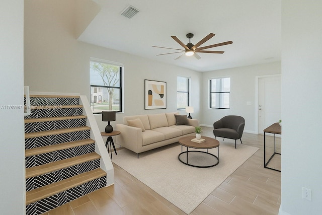 12950 SW 235th Ter, Homestead, FL 33032 - living area with wood finished floors, visible vents, ceiling fan, and a healthy amount of sunlight
