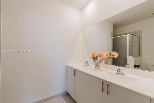 12950 SW 235th Ter, Homestead, FL 33032 - full bathroom featuring double vanity, a shower stall, tile patterned floors, and a sink