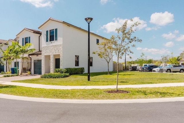 12950 SW 235th Ter, Homestead, FL 33032 - view of property exterior featuring a lawn, an attached garage, stone siding, and stucco siding