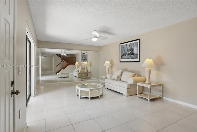2412 24th Way, West Palm Beach, FL 33407 - living room with a textured ceiling, ceiling fan, tile patterned flooring, and baseboards