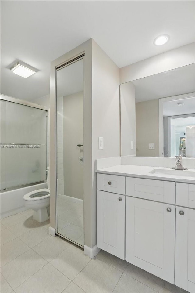 2412 24th Way, West Palm Beach, FL 33407 - full bathroom with shower / bath combination with glass door, vanity, toilet, baseboards, and tile patterned flooring