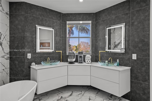 full bathroom with a freestanding bath, visible vents, vanity, tile walls, and a stall shower