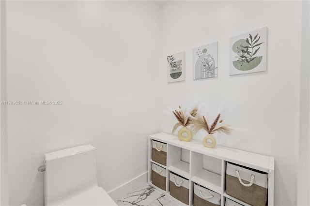 office area featuring baseboards, wood finished floors, and an inviting chandelier