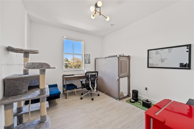 office space featuring a wall unit AC, visible vents, and light wood-style flooring