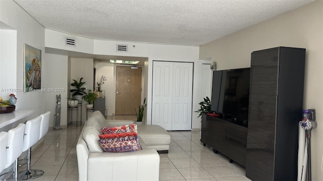 16485 E Collins Ave Unit 338, Sunny Isles Beach, FL 33160 - living room with light tile patterned floors, a textured ceiling, and visible vents