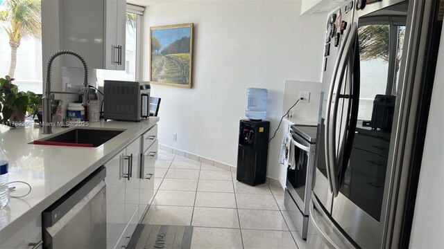 16485 E Collins Ave Unit 338, Sunny Isles Beach, FL 33160 - kitchen featuring a sink, appliances with stainless steel finishes, a wealth of natural light, and light countertops