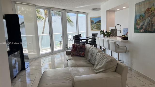 16485 E Collins Ave Unit 338, Sunny Isles Beach, FL 33160 - living room featuring baseboards, light tile patterned floors, and a wall of windows