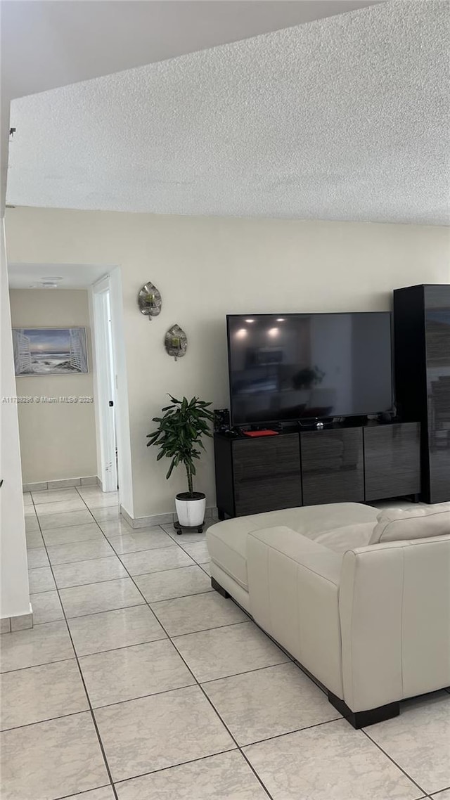 16485 E Collins Ave Unit 338, Sunny Isles Beach, FL 33160 - living area featuring light tile patterned floors, baseboards, and a textured ceiling