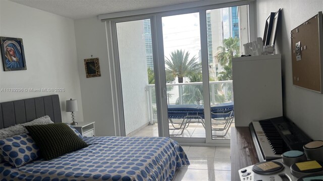 16485 E Collins Ave Unit 338, Sunny Isles Beach, FL 33160 - bedroom featuring a textured ceiling, multiple windows, and light tile patterned floors