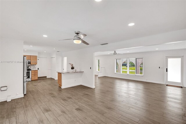 15440 SW 81st Ave, Palmetto Bay, FL 33157 - unfurnished living room featuring a ceiling fan, wood finished floors, recessed lighting, and baseboards