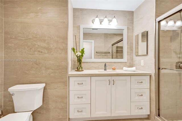 15440 SW 81st Ave, Palmetto Bay, FL 33157 - bathroom with tile walls, vanity, toilet, and a stall shower
