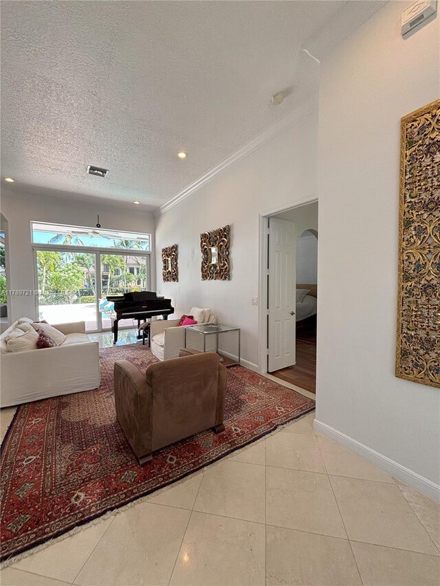 320 Windmill Palm Ave, Plantation, FL 33324 - living area with ornamental molding, arched walkways, a textured ceiling, tile patterned floors, and recessed lighting