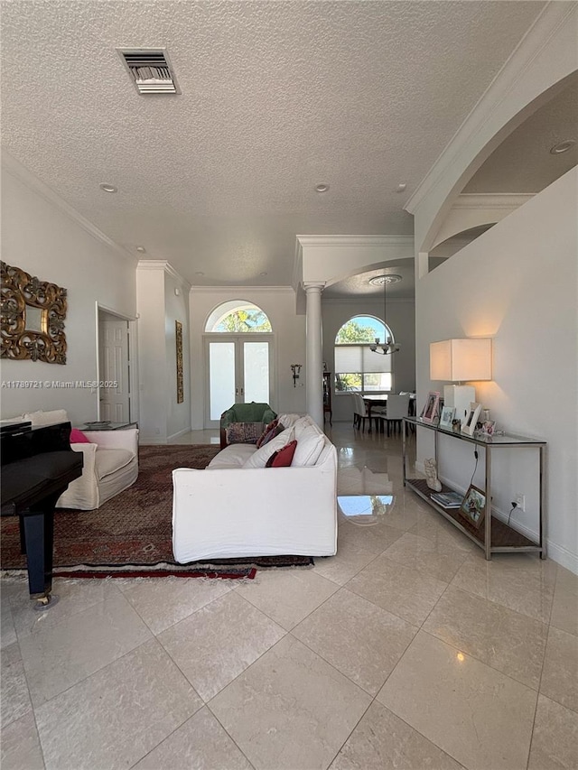 320 Windmill Palm Ave, Plantation, FL 33324 - living room featuring ornamental molding, decorative columns, and a textured ceiling