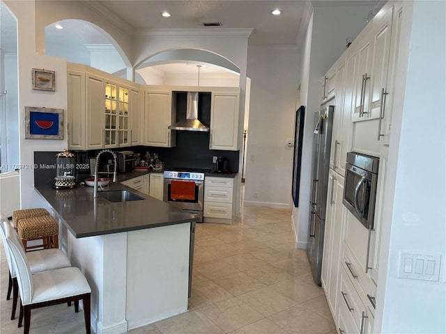 320 Windmill Palm Ave, Plantation, FL 33324 - kitchen featuring stainless steel appliances, wall chimney range hood, a peninsula, dark countertops, and ornamental molding