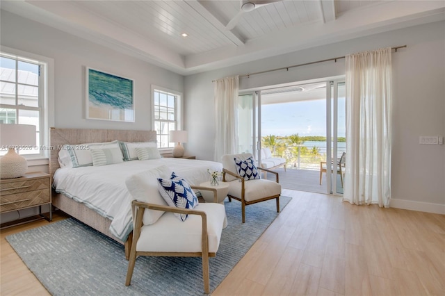 bedroom with baseboards, access to outside, beam ceiling, and light wood-style flooring