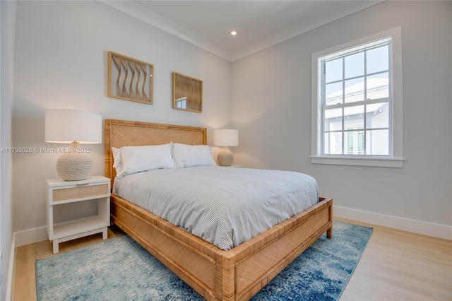 bedroom with crown molding, baseboards, recessed lighting, and wood finished floors