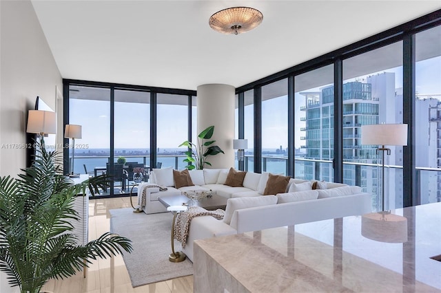 480 NE 31st St Unit 4701, Miami, FL 33137 - living area with floor to ceiling windows, light wood-style flooring, and a water view