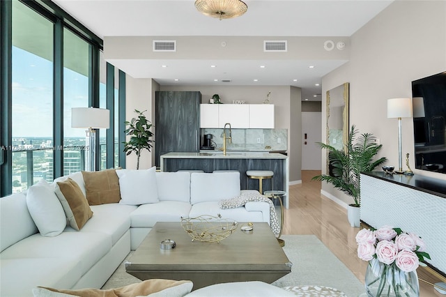480 NE 31st St Unit 4701, Miami, FL 33137 - living area with baseboards, light wood finished floors, visible vents, and floor to ceiling windows