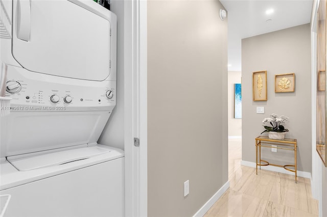 480 NE 31st St Unit 4701, Miami, FL 33137 - laundry area featuring baseboards, marble finish floor, stacked washer / dryer, and laundry area