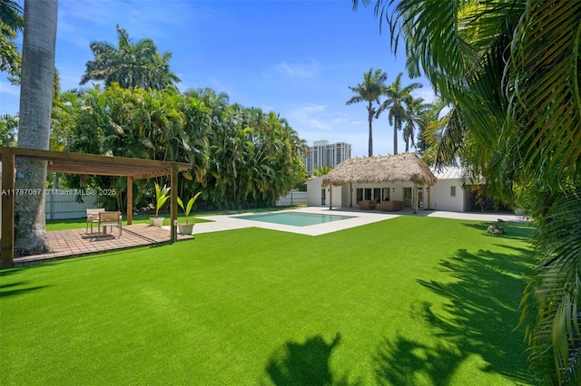 view of yard featuring fence, an outdoor pool, and a patio area