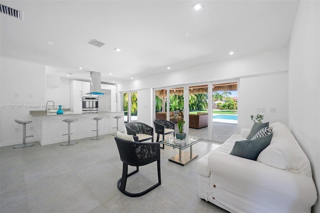 living area featuring recessed lighting and visible vents