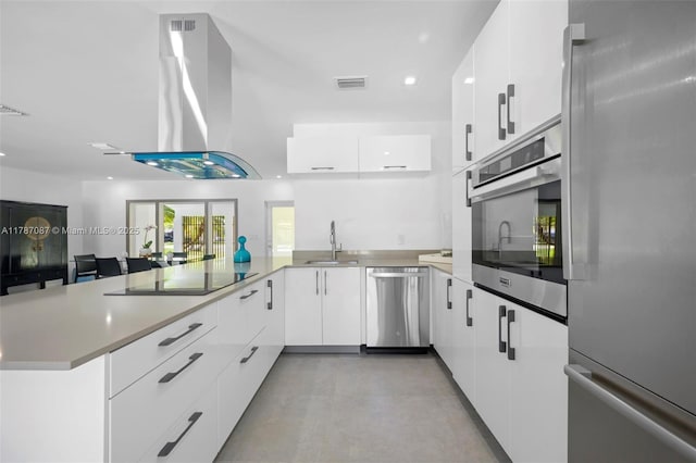 kitchen featuring modern cabinets, a peninsula, stainless steel appliances, and visible vents