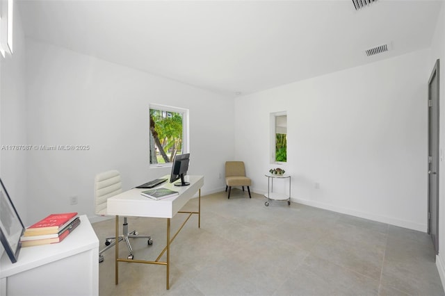 home office featuring baseboards and visible vents