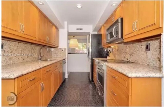 3769 NE 209th Ter, Aventura, FL 33180 - kitchen with stainless steel appliances, a sink, backsplash, recessed lighting, and light stone counters