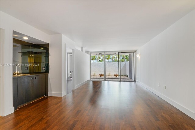 3769 NE 209th Ter, Aventura, FL 33180 - unfurnished living room featuring dark wood-type flooring and baseboards