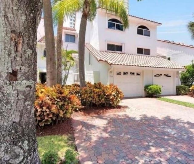 3769 NE 209th Ter, Aventura, FL 33180 - mediterranean / spanish home featuring stucco siding, a tile roof, and decorative driveway