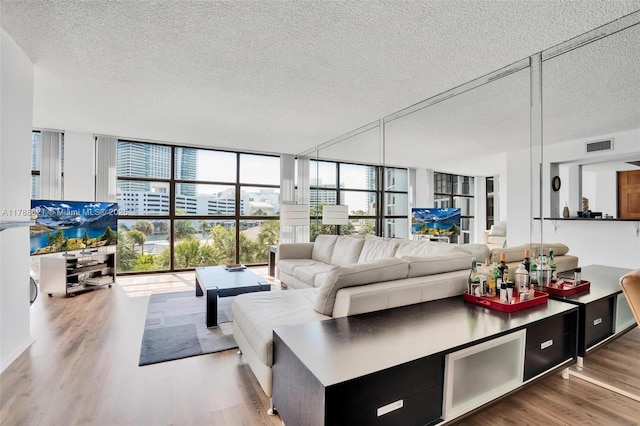 600 Parkview Dr Unit 422, Hallandale Beach, FL 33009 - living area with visible vents, wood finished floors, a textured ceiling, and floor to ceiling windows