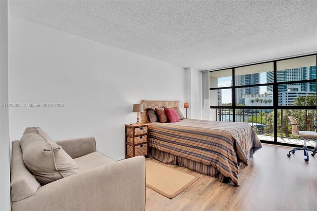 600 Parkview Dr Unit 422, Hallandale Beach, FL 33009 - bedroom featuring a wall of windows, a textured ceiling, and wood finished floors