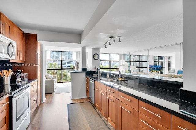 600 Parkview Dr Unit 422, Hallandale Beach, FL 33009 - kitchen featuring appliances with stainless steel finishes, open floor plan, and plenty of natural light