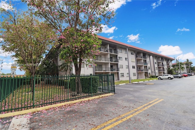 8101 SW 72nd Ave Unit 304W, Miami, FL 33143 - view of apartment building / complex featuring uncovered parking and fence
