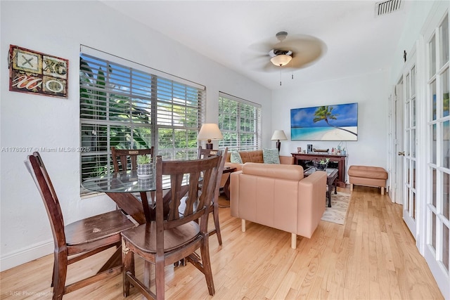 interior space with baseboards, visible vents, ceiling fan, and light wood-style flooring
