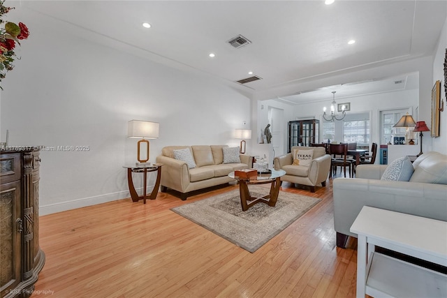 living room featuring a chandelier, visible vents, light wood finished floors, and recessed lighting