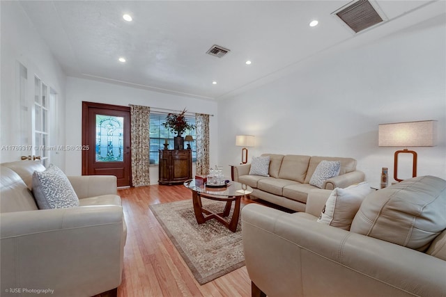 living area with recessed lighting, visible vents, and light wood-type flooring